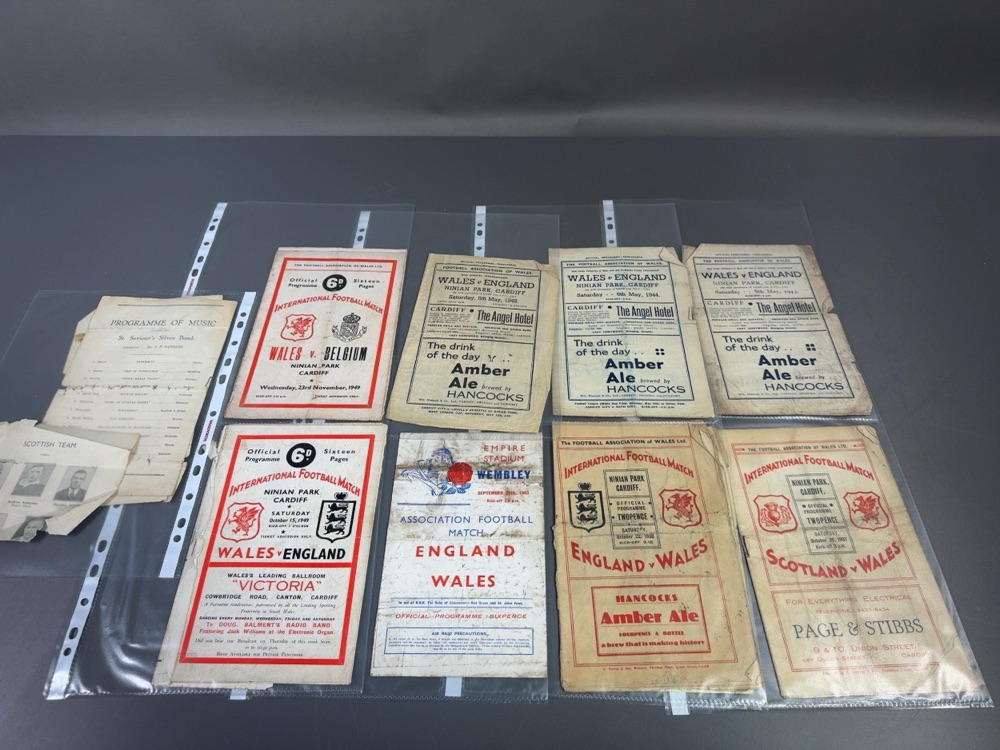 nine vintage Football Association of Wales match programmes and ephemera laid out together
